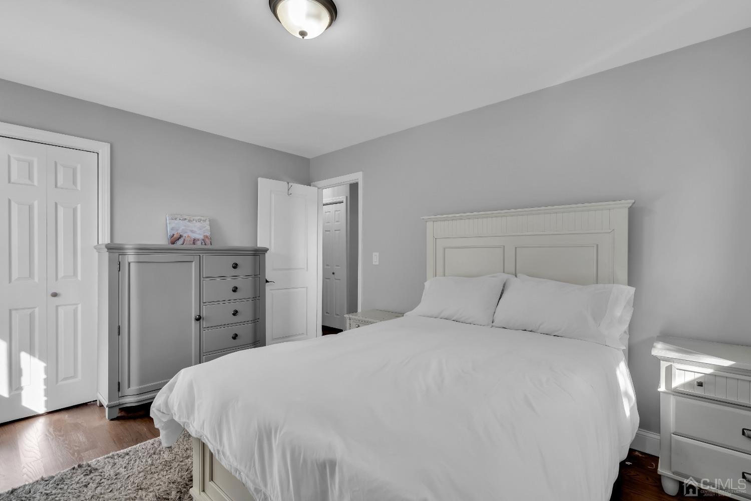 435 Teaneck Road, Unit 21 Ridgefield Park, NJ 07660 - Photo 14 of 20 a bedroom with a bed and wooden floor