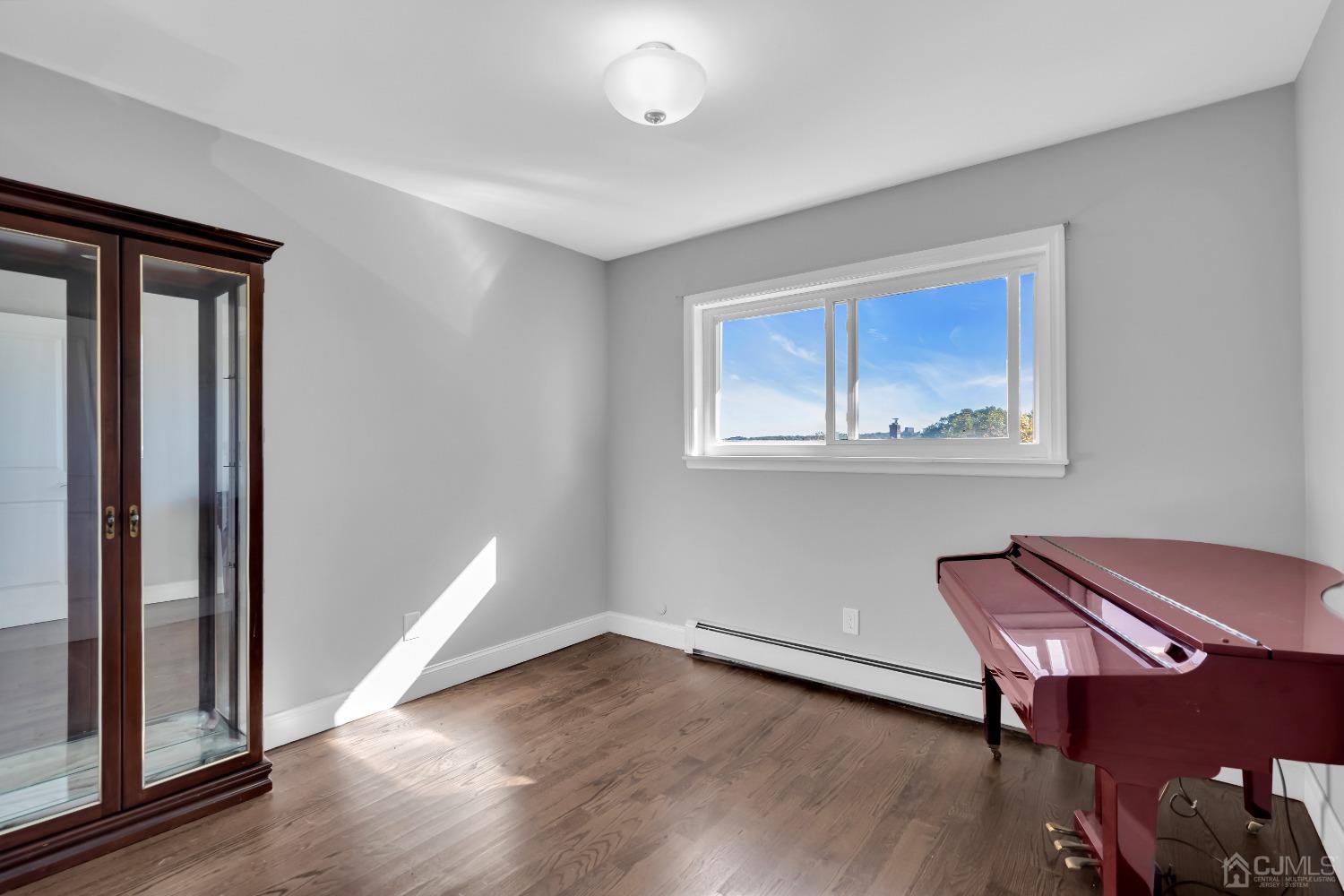 435 Teaneck Road, Unit 21 Ridgefield Park, NJ 07660 - Photo 15 of 20 a view of room with window and wooden floor
