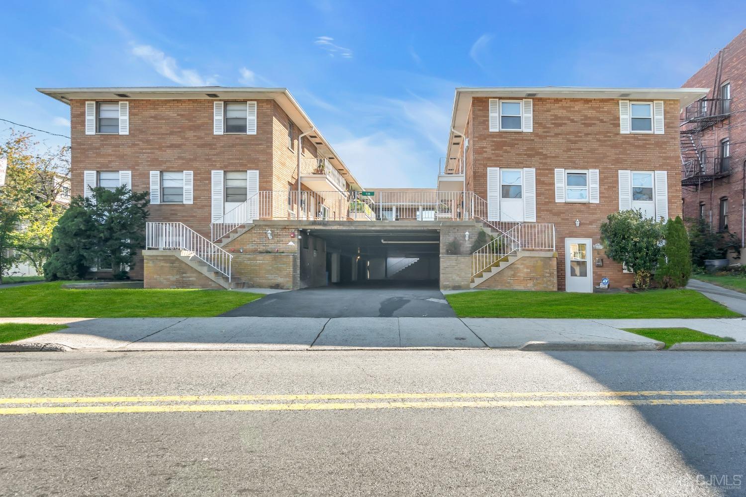 435 Teaneck Road, Unit 21 Ridgefield Park, NJ 07660 - Photo 20 of 20 a front view of a house with a yard and a garage