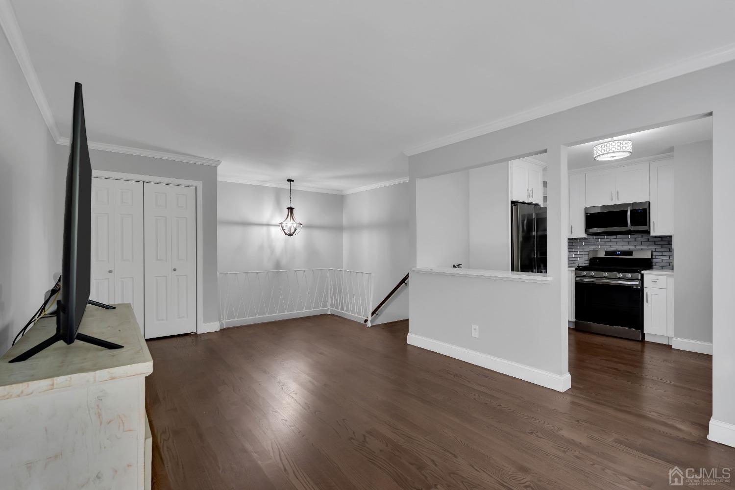 435 Teaneck Road, Unit 21 Ridgefield Park, NJ 07660 - Photo 2 of 20 a view of a kitchen with wooden floor and electronic appliances