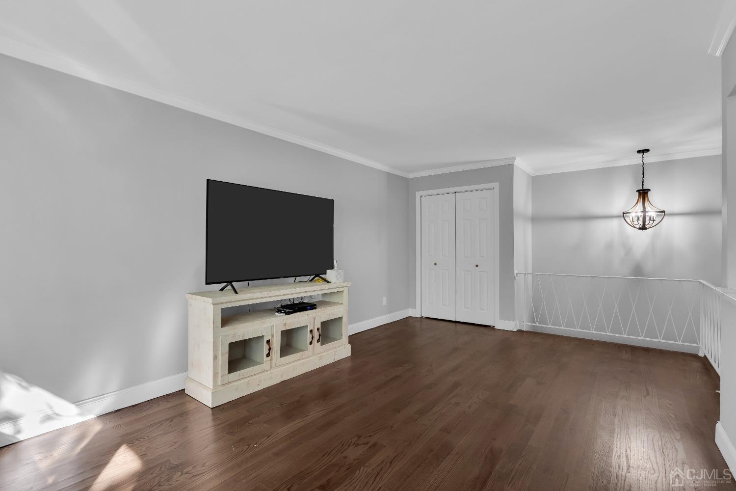 435 Teaneck Road, Unit 21 Ridgefield Park, NJ 07660 - Photo 4 of 20 a view of a livingroom with wooden floor and a flat screen tv