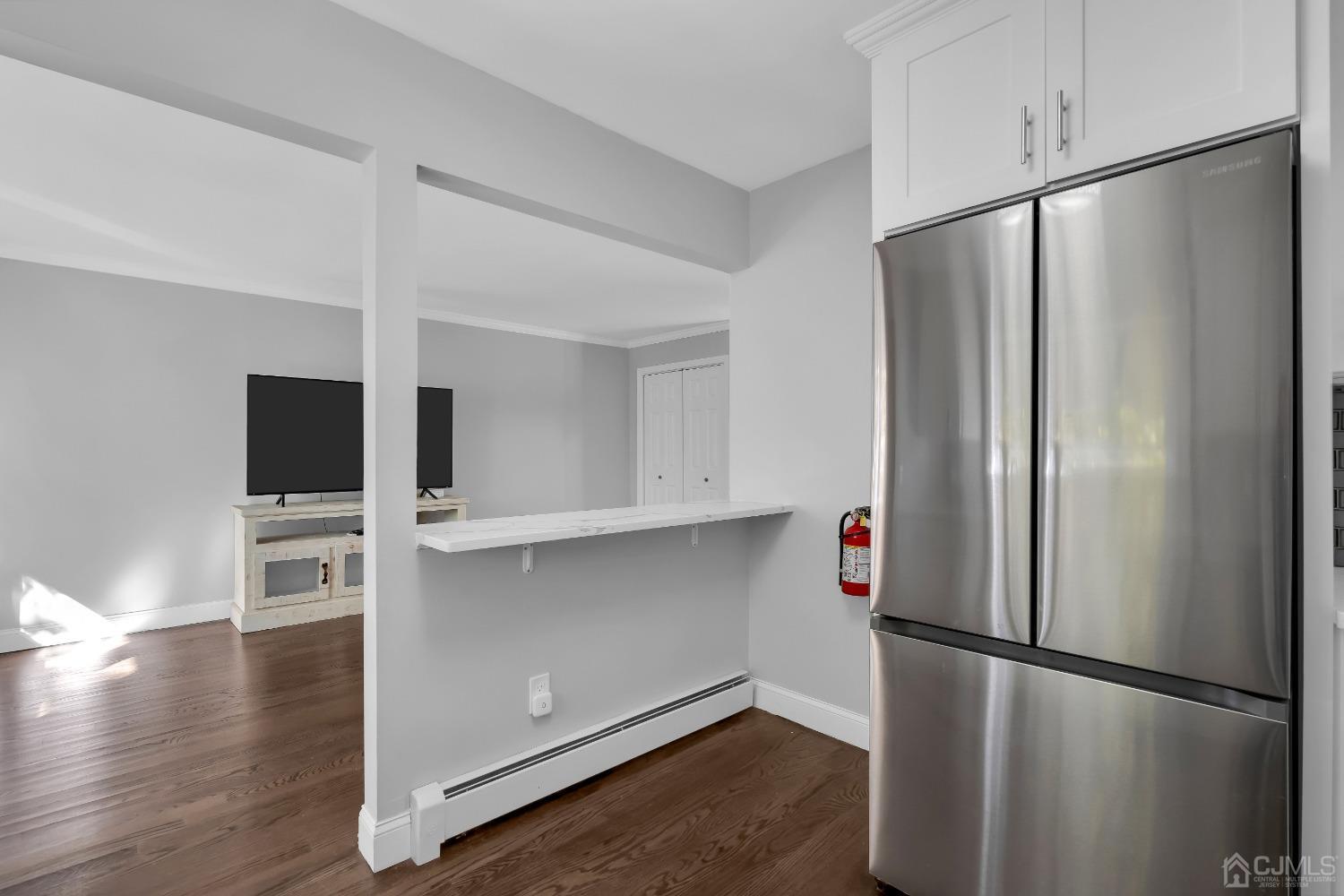 435 Teaneck Road, Unit 21 Ridgefield Park, NJ 07660 - Photo 5 of 20 a kitchen with stainless steel appliances a refrigerator and wooden floor