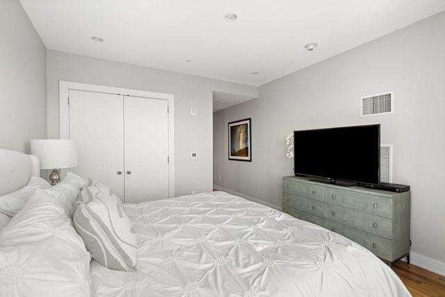 a bedroom with a flat screen tv and a bed