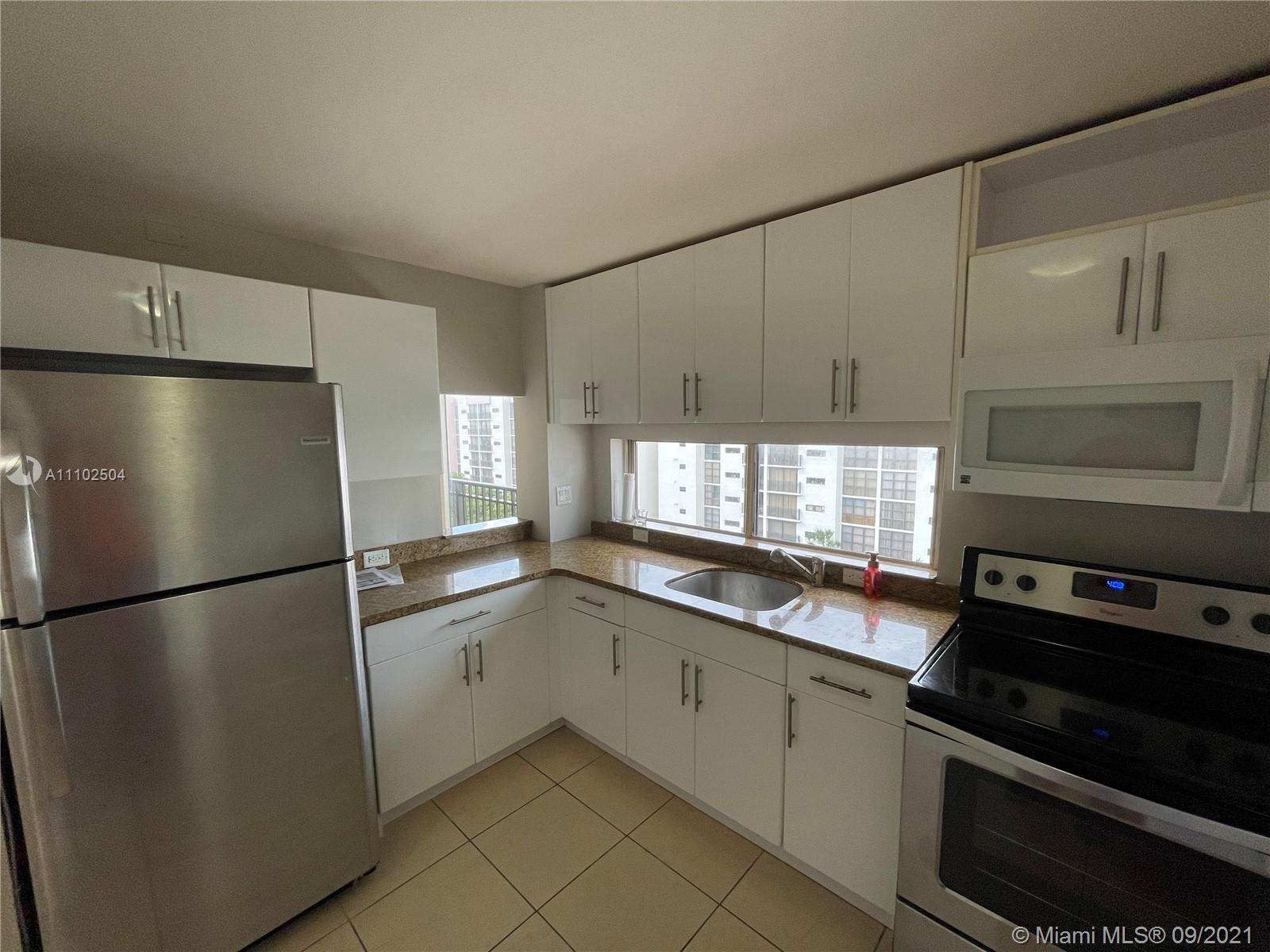 16909 North Bay Road, Unit 807 Sunny Isles Beach, FL 33160 - Photo 6 of 17 a kitchen with stainless steel appliances a refrigerator sink and microwave