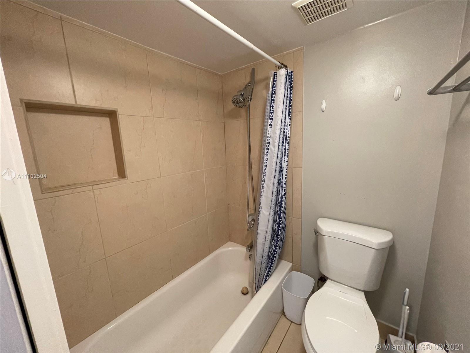 16909 North Bay Road, Unit 807 Sunny Isles Beach, FL 33160 - Photo 9 of 17 a white toilet sitting next to a bath tub