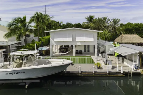a view of house with swimming pool yard and outdoor seating