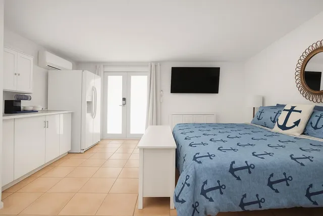 a bedroom with a bed and a television