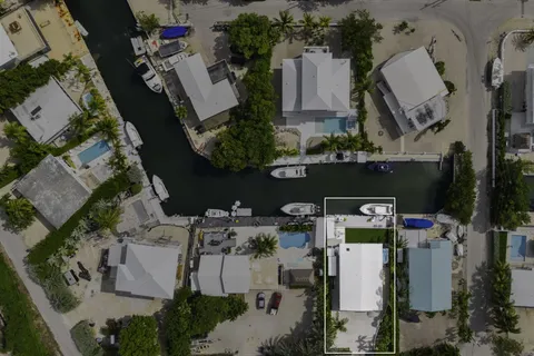 an aerial view of multiple houses with yard