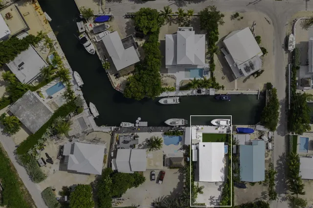 an aerial view of multiple houses with yard
