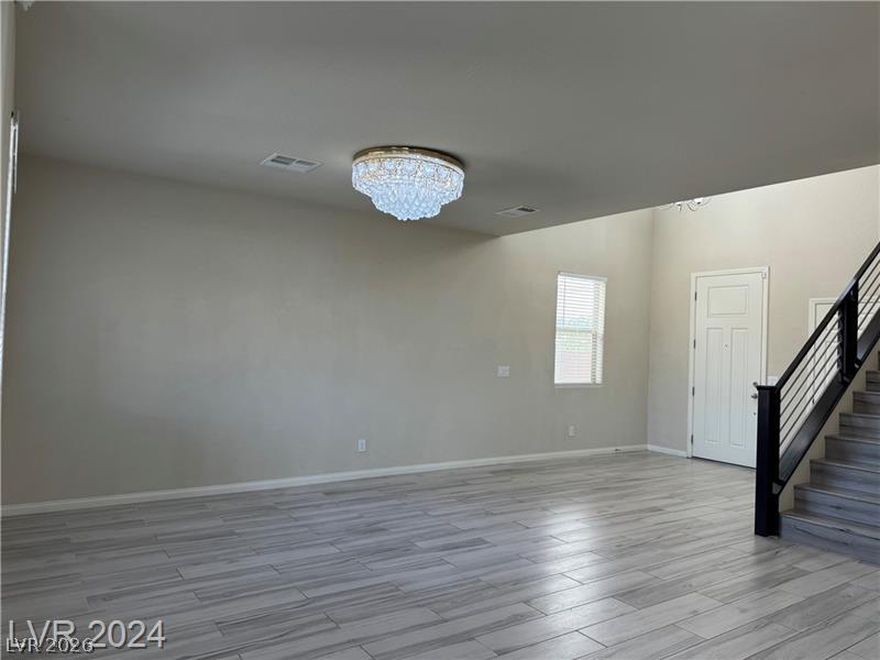 9056 Tony Ridge Avenue Las Vegas, NV 89148 - Photo 14 of 32 A spacious living area features high ceilings and wood-look tile flooring.
