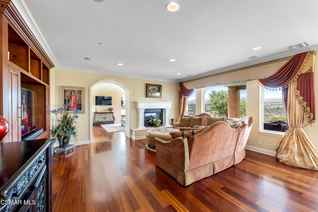 6717 Aspen Hills Drive Moorpark, CA 93021 - Photo 13 of 44 a living room with fireplace furniture and a large window