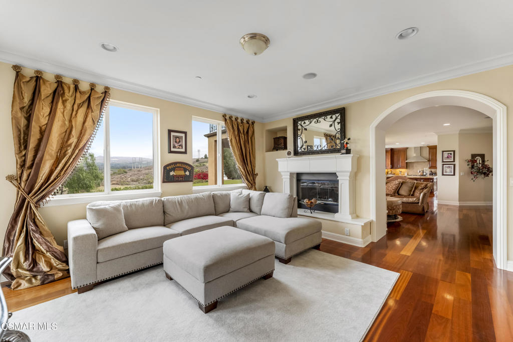 6717 Aspen Hills Drive Moorpark, CA 93021 - Photo 20 of 44 a living room with furniture fireplace and a large window