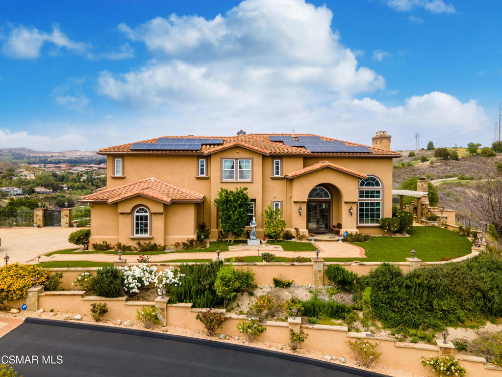 6717 Aspen Hills Drive Moorpark, CA 93021 - Photo 3 of 44 a front view of a house with garden