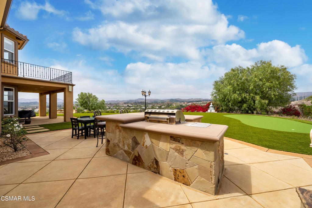 6717 Aspen Hills Drive Moorpark, CA 93021 - Photo 34 of 44 a view of a patio with a table and chairs