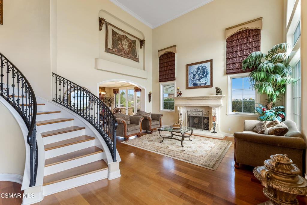 6717 Aspen Hills Drive Moorpark, CA 93021 - Photo 6 of 44 a living room with furniture a fireplace and a potted plant