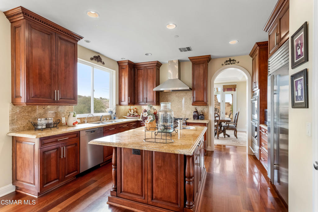 6717 Aspen Hills Drive Moorpark, CA 93021 - Photo 9 of 44 a kitchen with granite countertop a sink stove and cabinets