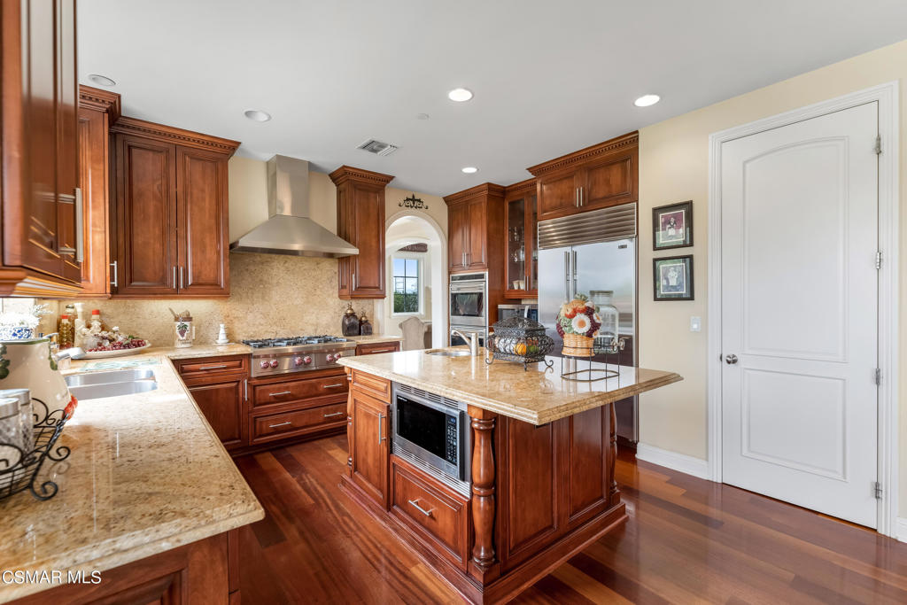 6717 Aspen Hills Drive Moorpark, CA 93021 - Photo 10 of 44 a kitchen with stainless steel appliances granite countertop a sink stove and refrigerator