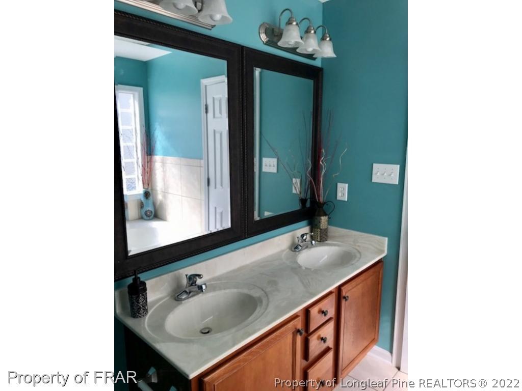2309 Chasewater Road Fayetteville, NC 28306 - Photo 12 of 31 a bathroom with a sink and a mirror