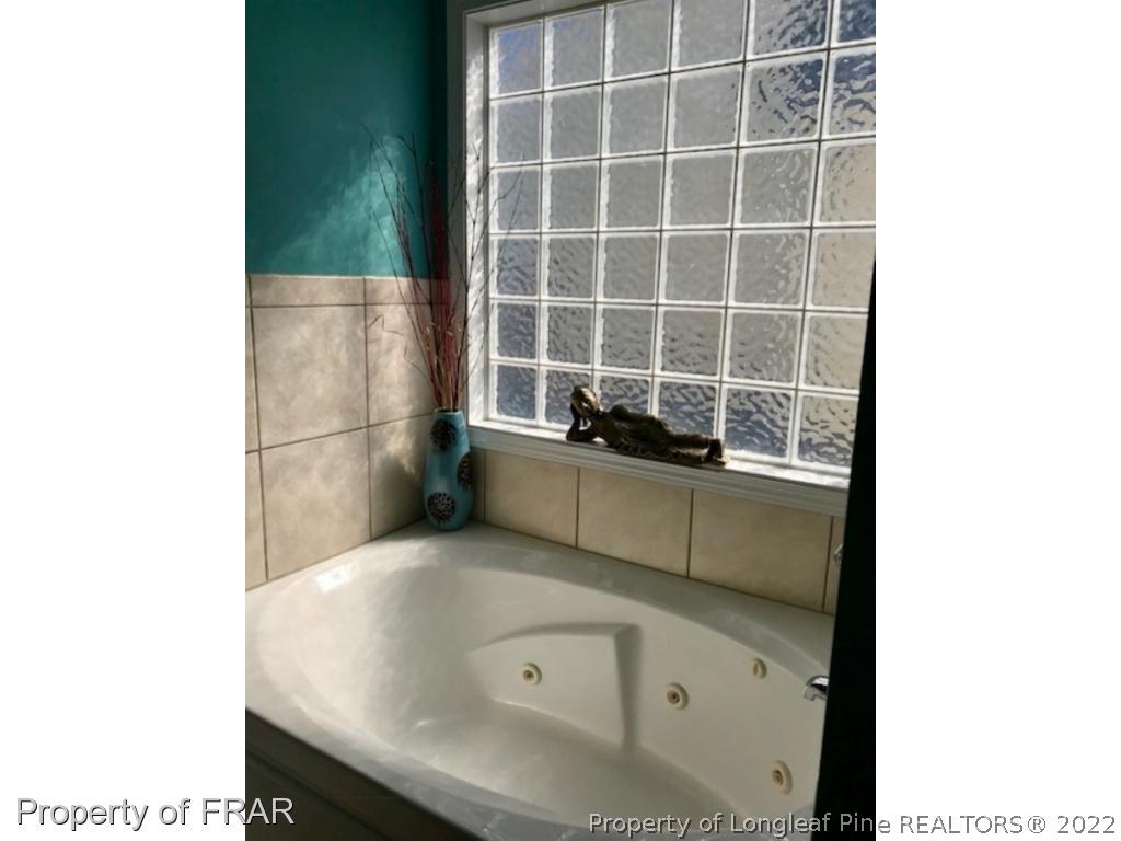 2309 Chasewater Road Fayetteville, NC 28306 - Photo 14 of 31 a bathroom with a tub and shower