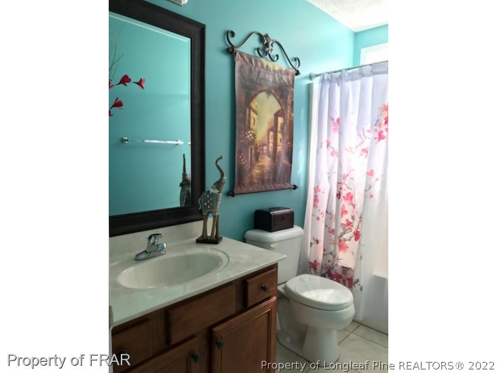 2309 Chasewater Road Fayetteville, NC 28306 - Photo 17 of 31 a bathroom with a sink toilet and shower