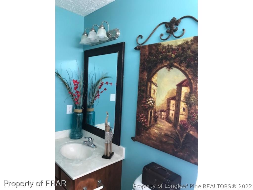 2309 Chasewater Road Fayetteville, NC 28306 - Photo 18 of 31 a bathroom with a sink and a mirror
