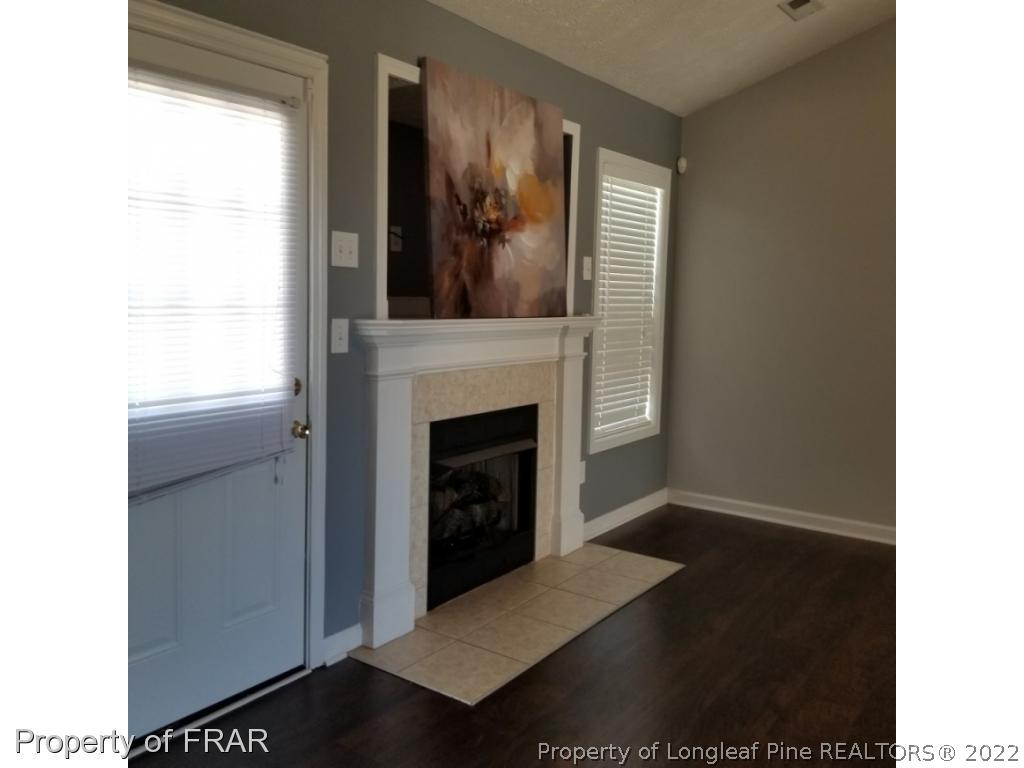 2309 Chasewater Road Fayetteville, NC 28306 - Photo 4 of 31 a view of a livingroom with a fireplace and window