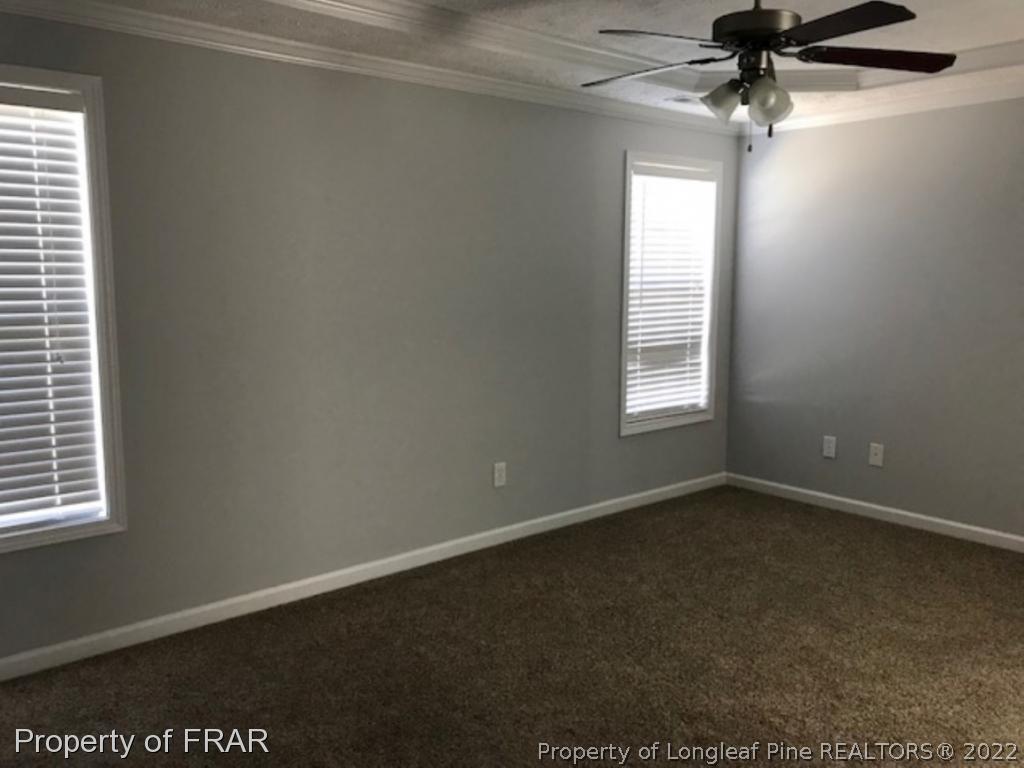 2309 Chasewater Road Fayetteville, NC 28306 - Photo 10 of 31 an empty room with a window and a fan
