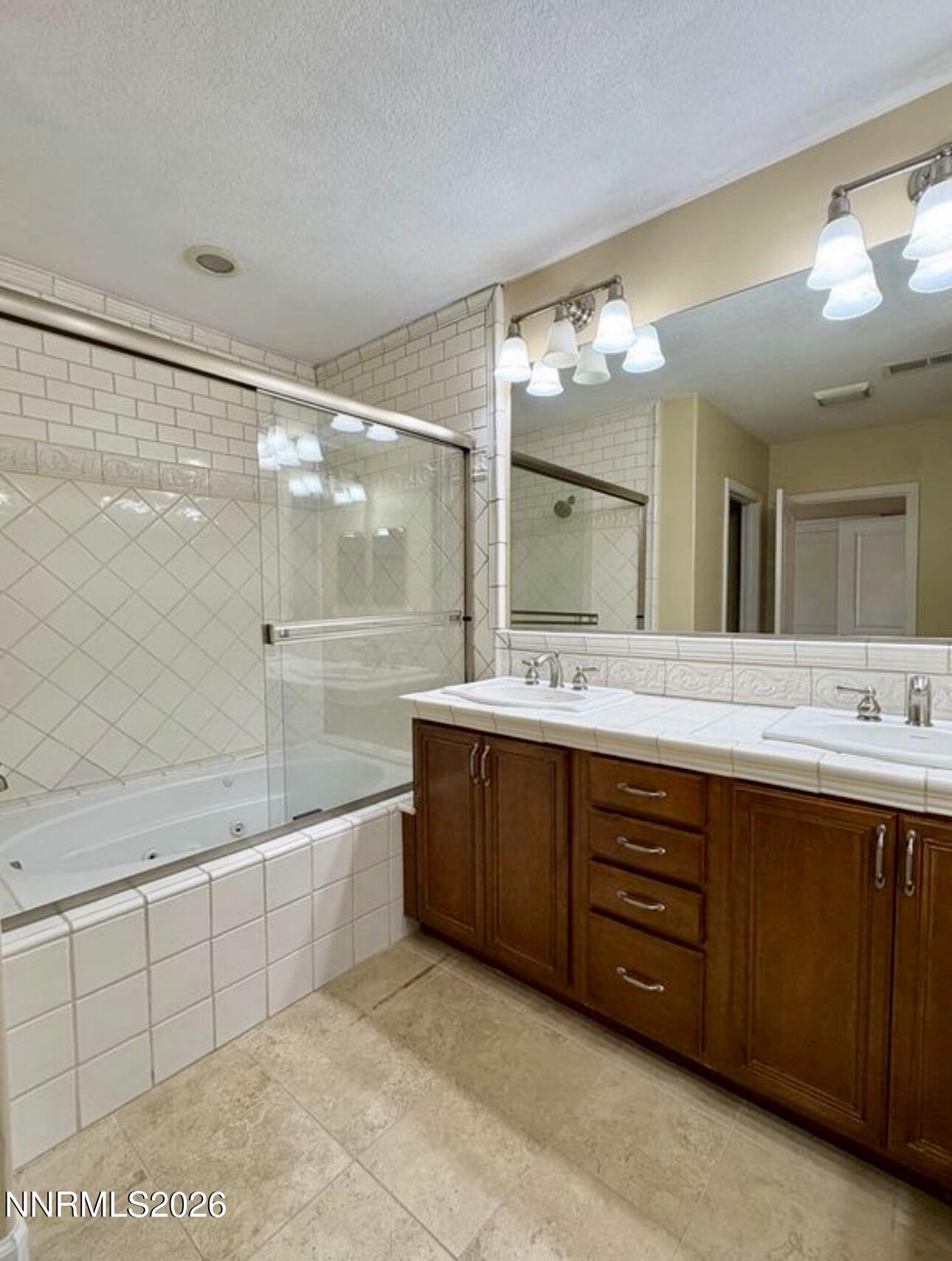 7616 Stone Bluff Way Reno, NV 89523 - Photo 14 of 18 a bathroom with a sink mirror and a bathtub