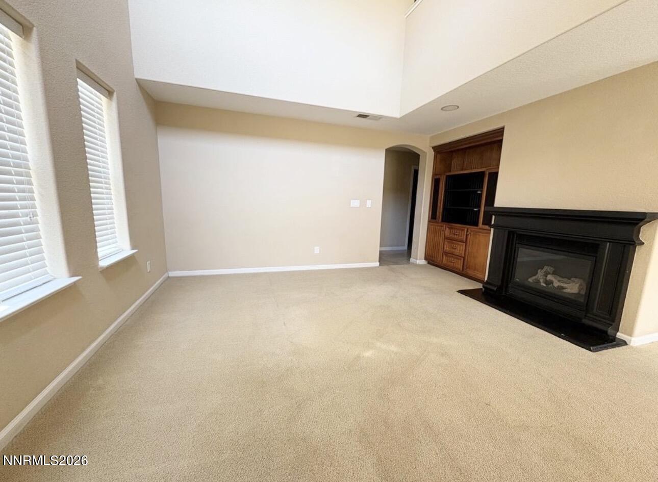 7616 Stone Bluff Way Reno, NV 89523 - Photo 2 of 18 a view of an empty room with a fireplace and a window