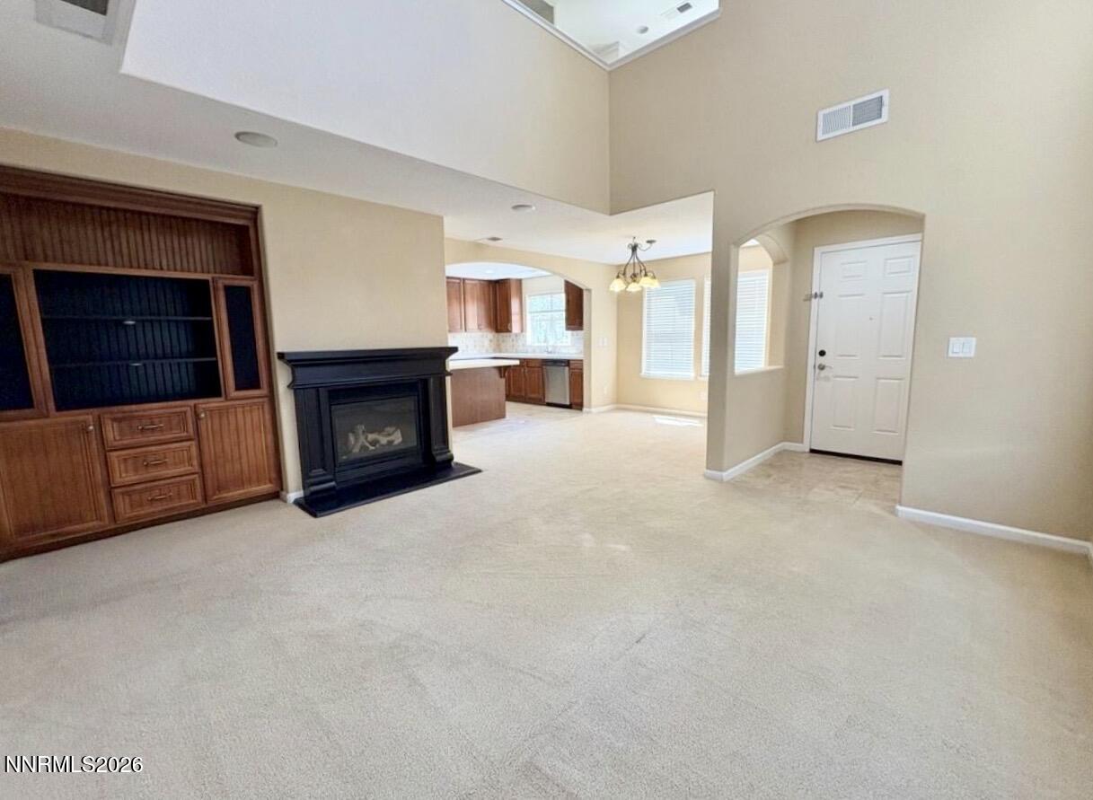 7616 Stone Bluff Way Reno, NV 89523 - Photo 3 of 18 a view of a livingroom with an empty space and a fireplace