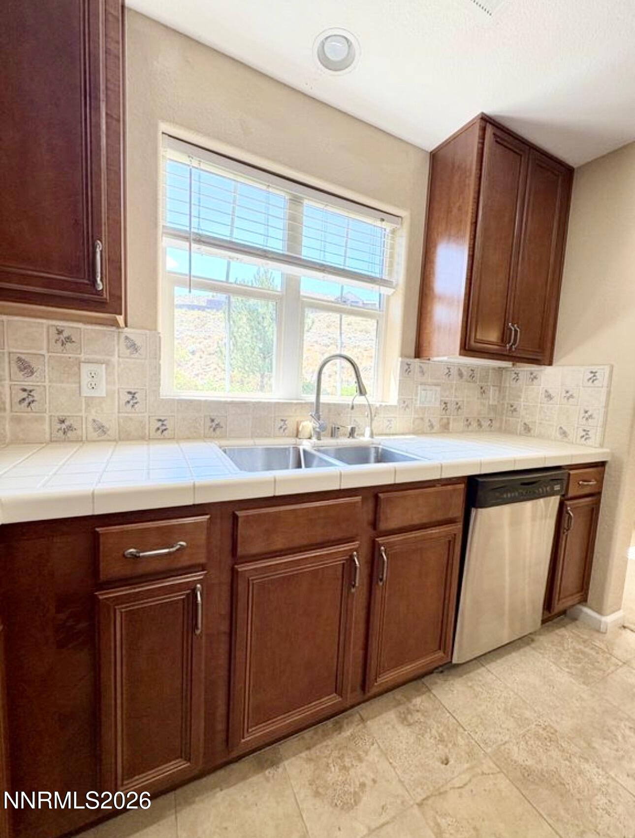 7616 Stone Bluff Way Reno, NV 89523 - Photo 6 of 18 a sink with granite countertop a sink and cabinets