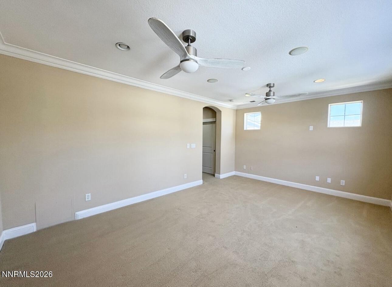 7616 Stone Bluff Way Reno, NV 89523 - Photo 9 of 18 an empty room with windows and ceiling fan