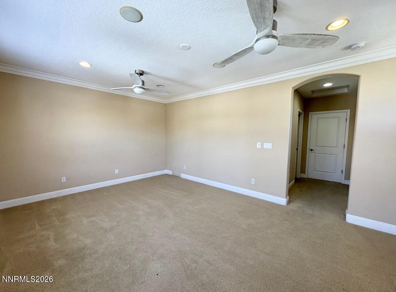 7616 Stone Bluff Way Reno, NV 89523 - Photo 10 of 18 an empty room with a ceiling fan and a window
