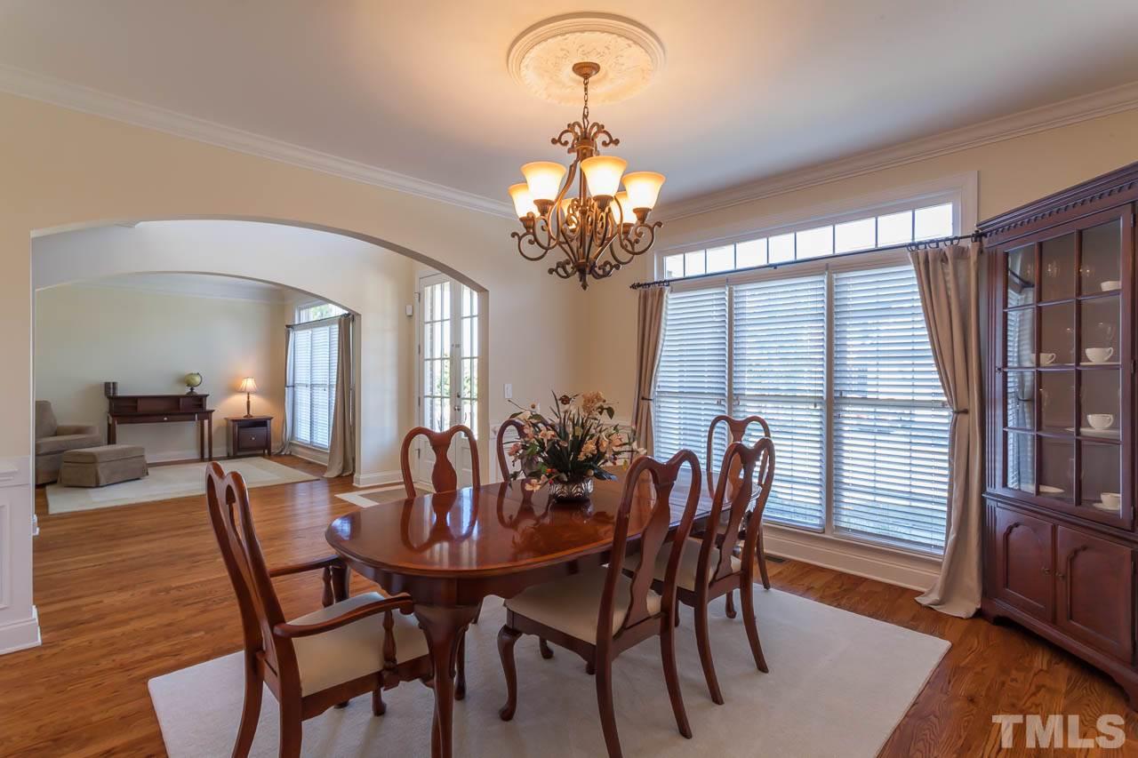 11825 Lowery Ridge Drive Raleigh, NC 27614 - Photo 2 of 25 a dining room with furniture a chandelier and wooden floor