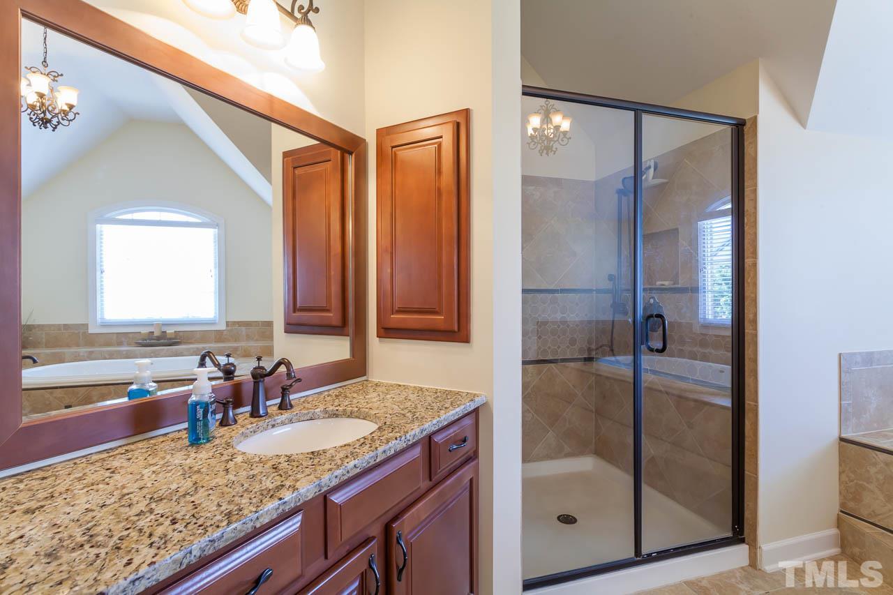 11825 Lowery Ridge Drive Raleigh, NC 27614 - Photo 14 of 25 a bathroom with a granite countertop sink and a mirror