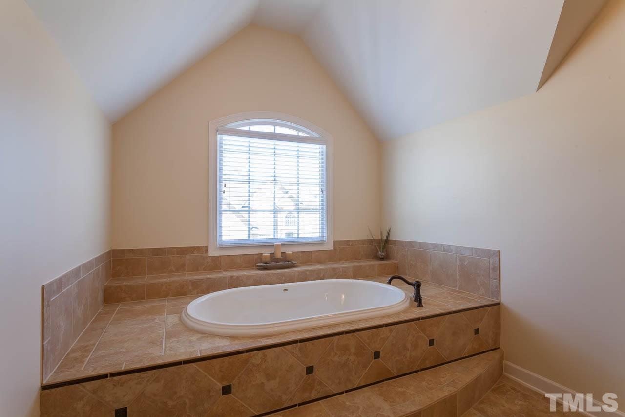 11825 Lowery Ridge Drive Raleigh, NC 27614 - Photo 15 of 25 a bathroom with a sink and a bathtub