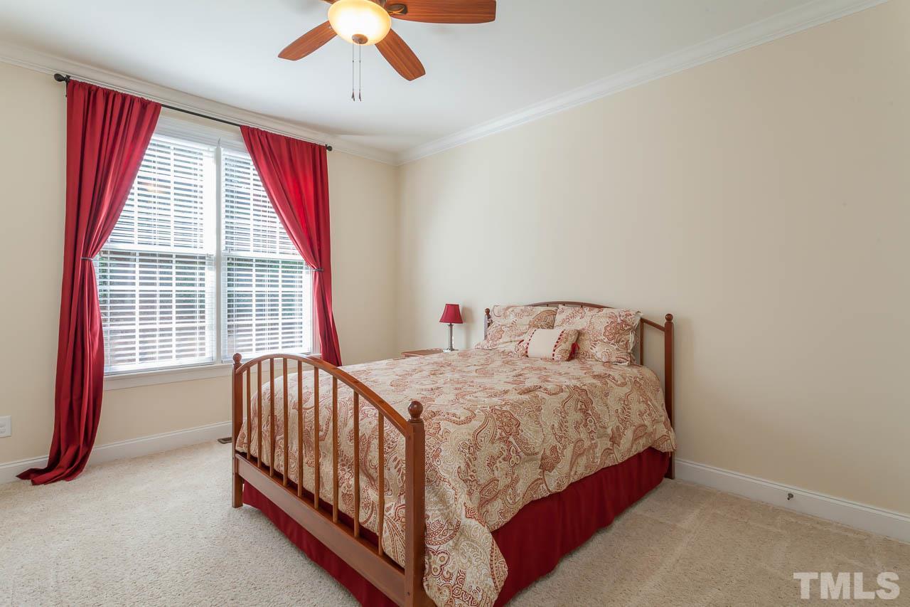 11825 Lowery Ridge Drive Raleigh, NC 27614 - Photo 16 of 25 a bedroom with a bed and a large window