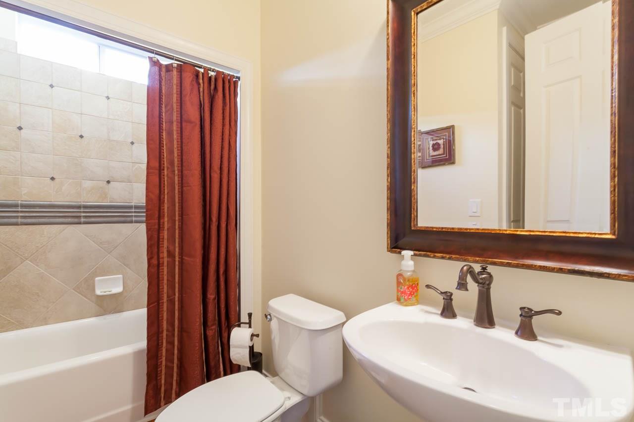 11825 Lowery Ridge Drive Raleigh, NC 27614 - Photo 17 of 25 a bathroom with a sink a toilet and shower curtain