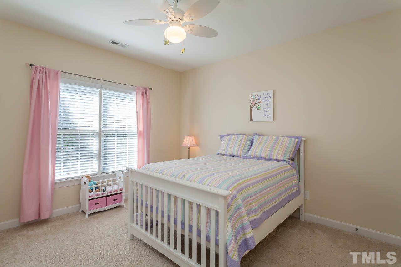 11825 Lowery Ridge Drive Raleigh, NC 27614 - Photo 18 of 25 a bedroom with a bed and a window