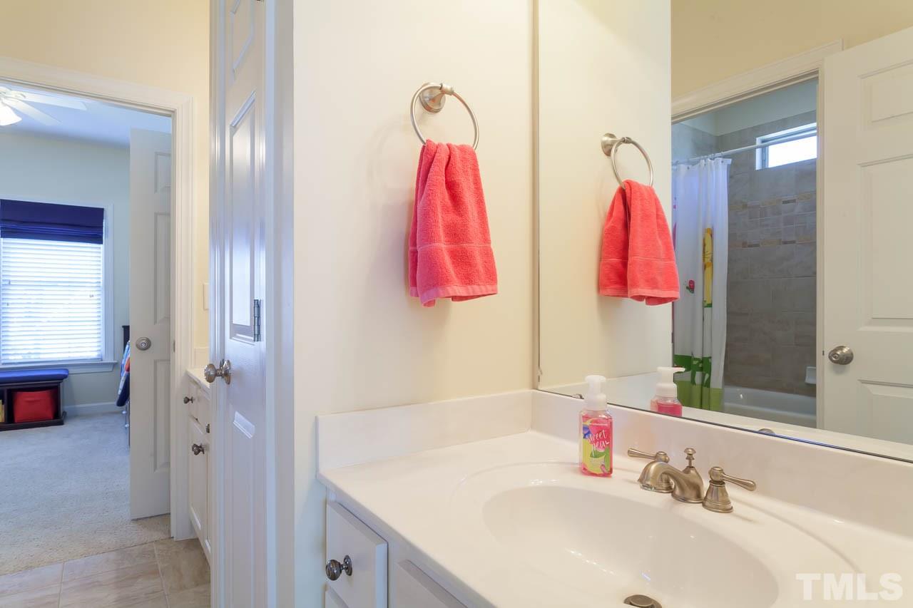 11825 Lowery Ridge Drive Raleigh, NC 27614 - Photo 20 of 25 a bathroom with a sink and a mirror