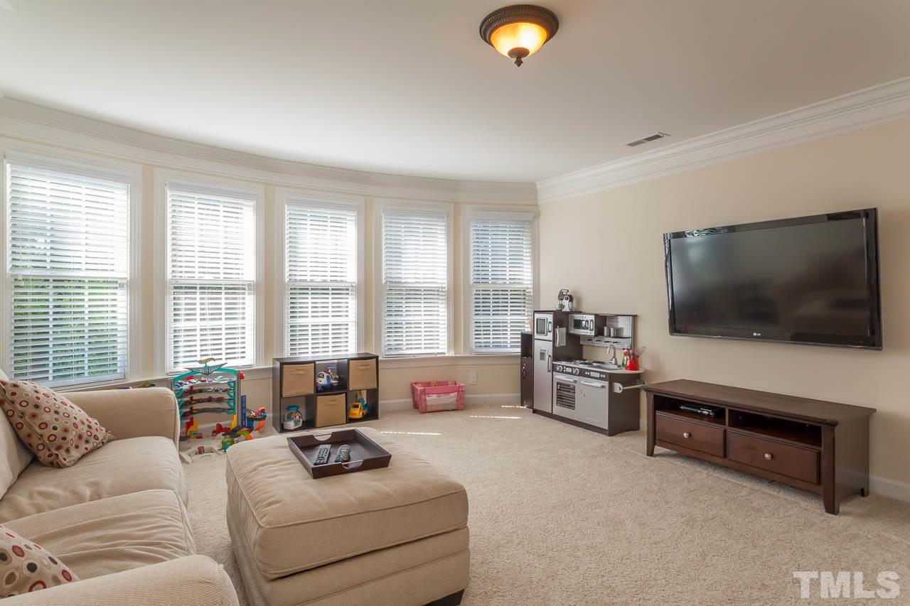 11825 Lowery Ridge Drive Raleigh, NC 27614 - Photo 22 of 25 a living room with furniture and a flat screen tv