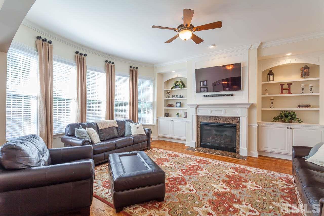 11825 Lowery Ridge Drive Raleigh, NC 27614 - Photo 5 of 25 a living room with furniture a fireplace and a flat screen tv