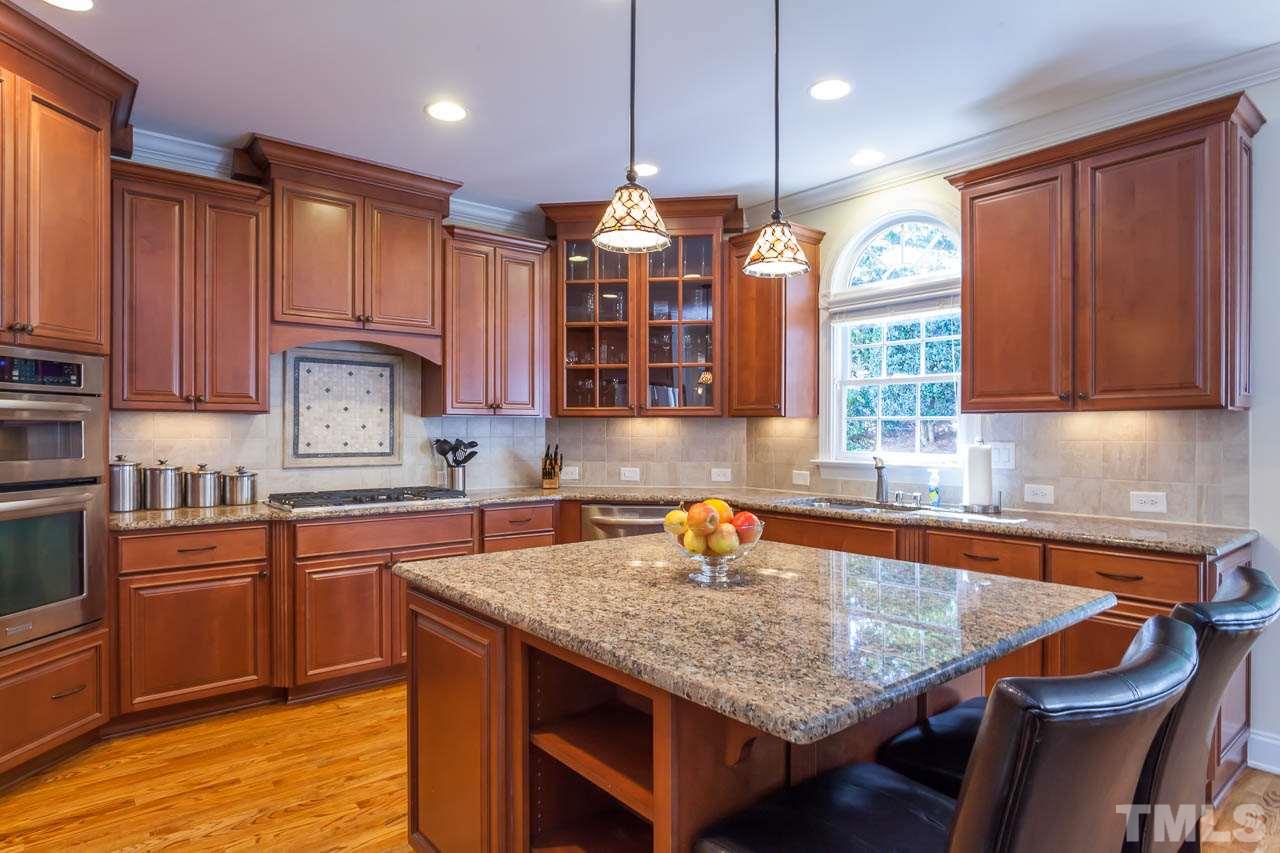 11825 Lowery Ridge Drive Raleigh, NC 27614 - Photo 7 of 25 a kitchen with granite countertop a sink a counter space appliances and cabinets