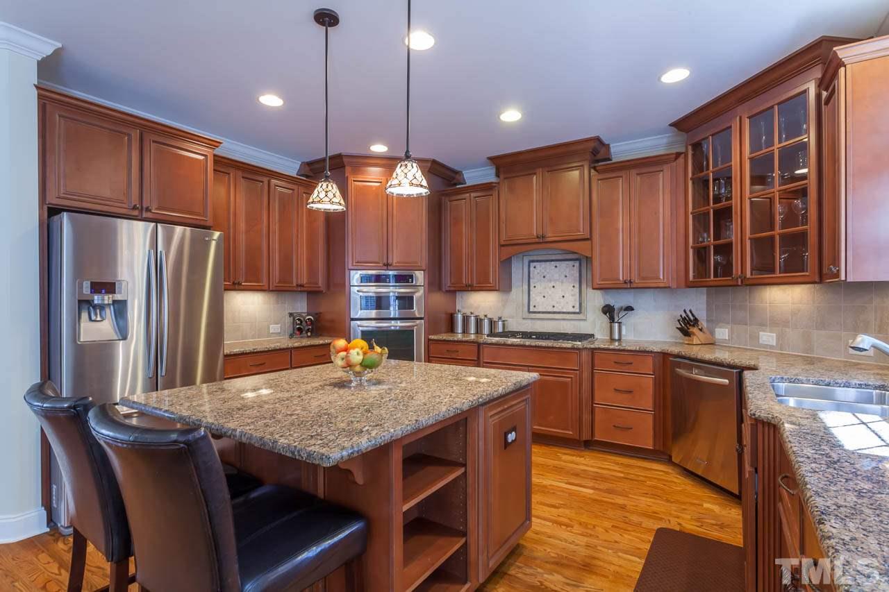 11825 Lowery Ridge Drive Raleigh, NC 27614 - Photo 8 of 25 a kitchen with stainless steel appliances granite countertop a stove refrigerator sink and microwave