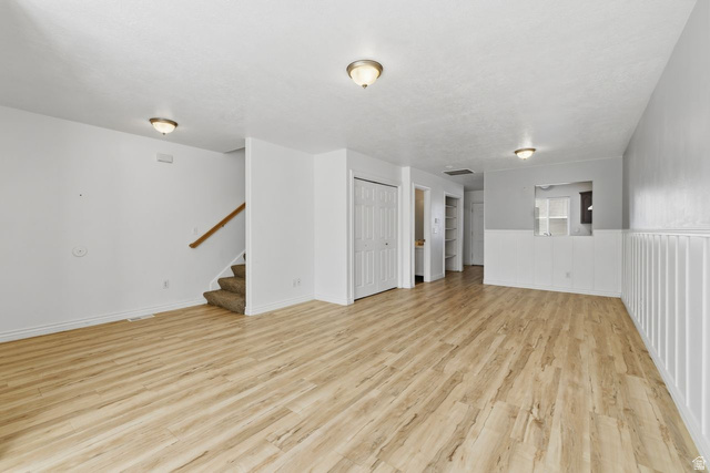 977 East 100 South Payson, UT 84651 - Photo 8 of 19 Unfurnished living room featuring light wood-type flooring and wainscoting