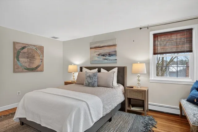 a bedroom with double bed and a window