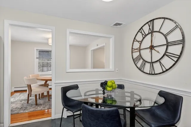 a dining room with furniture and a wooden floor