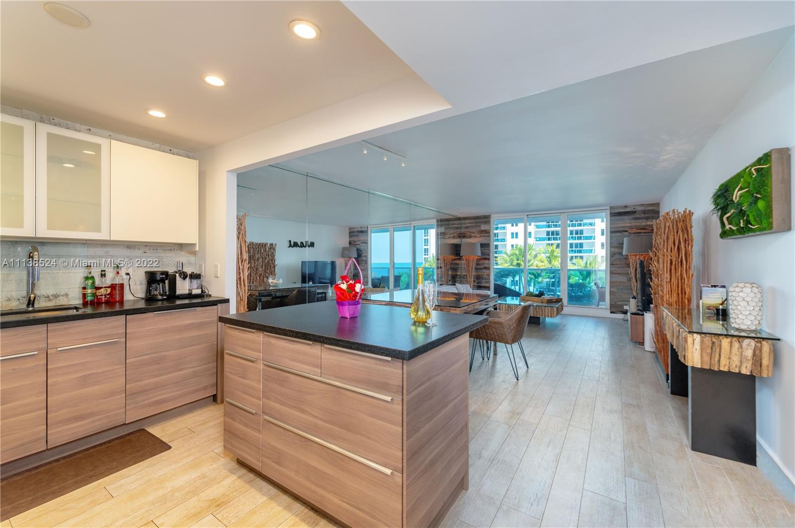 Mid Beach Miami Beach, FL 33139 - Photo 7 of 18 a kitchen that has a lot of cabinets a sink and a stove in it