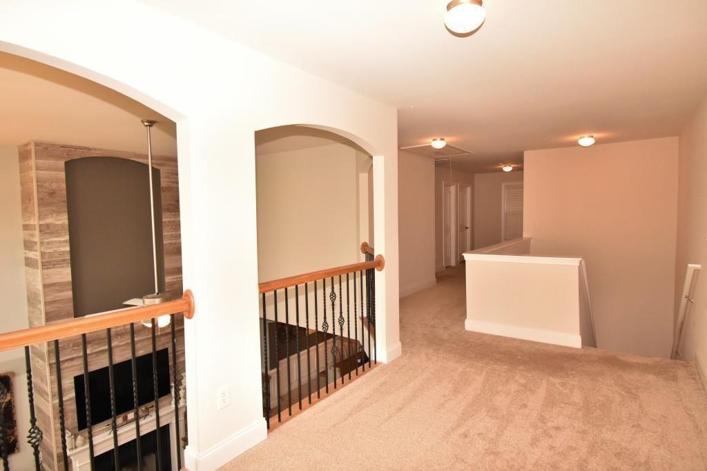 5691 Apple Grove Road Northeast Buford, GA 30519 - Photo 17 of 23 a view of a hallway with windows and stairs