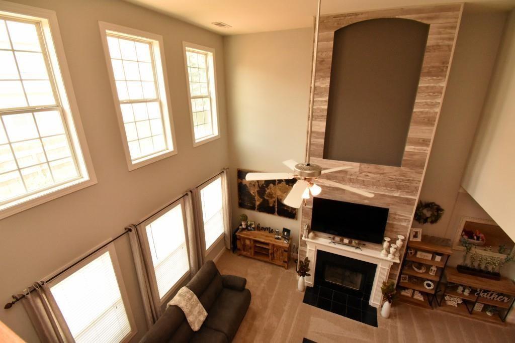 5691 Apple Grove Road Northeast Buford, GA 30519 - Photo 18 of 23 a living room with furniture and a flat screen tv